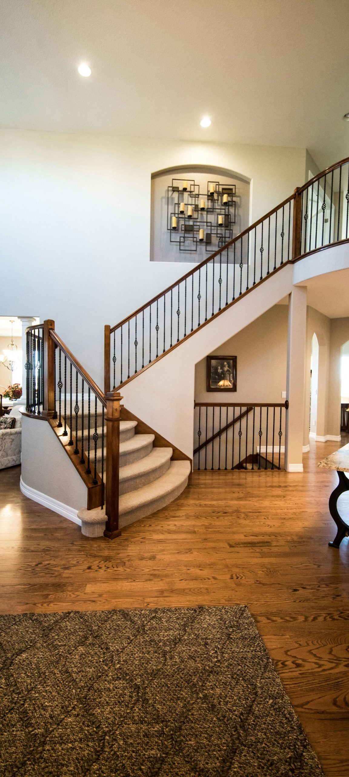 Spacious modern interior showcasing a stylish wooden staircase and elegant decor.
